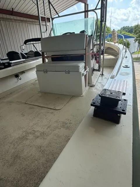 Slide: The Image of A 1974 Aquasport WT20 boat in a covered area. It features a central helm console and seating. - 7