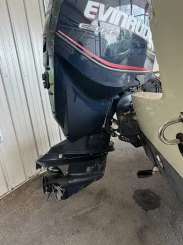 Slide: The Image of An Evinrude outboard motor is attached to a boat, situated in a covered area. - 6