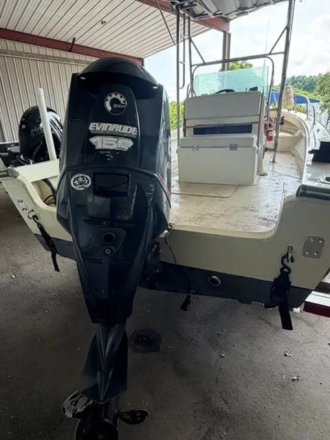 Slide: The Image of A 1974 Aquasport WT20 boat with an Evinrude 150 engine, parked under a shelter. - 5