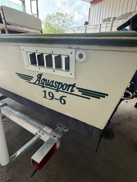 Slide: The Image of A 1974 Aquasport boat on a trailer, featuring the model name "19-6" on the side. - 3