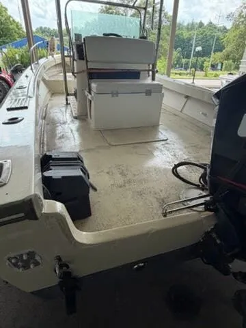 Slide: The Image of The image shows the deck of a 1974 Aquasport WT20 boat with seating and an engine. - 4