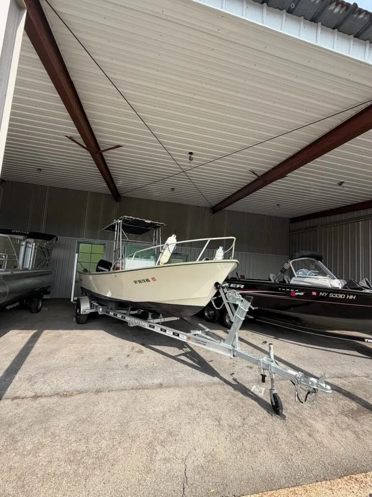 Slide: The Image of A 1974 Aquasport WT20 on a trailer in a covered area. - 12