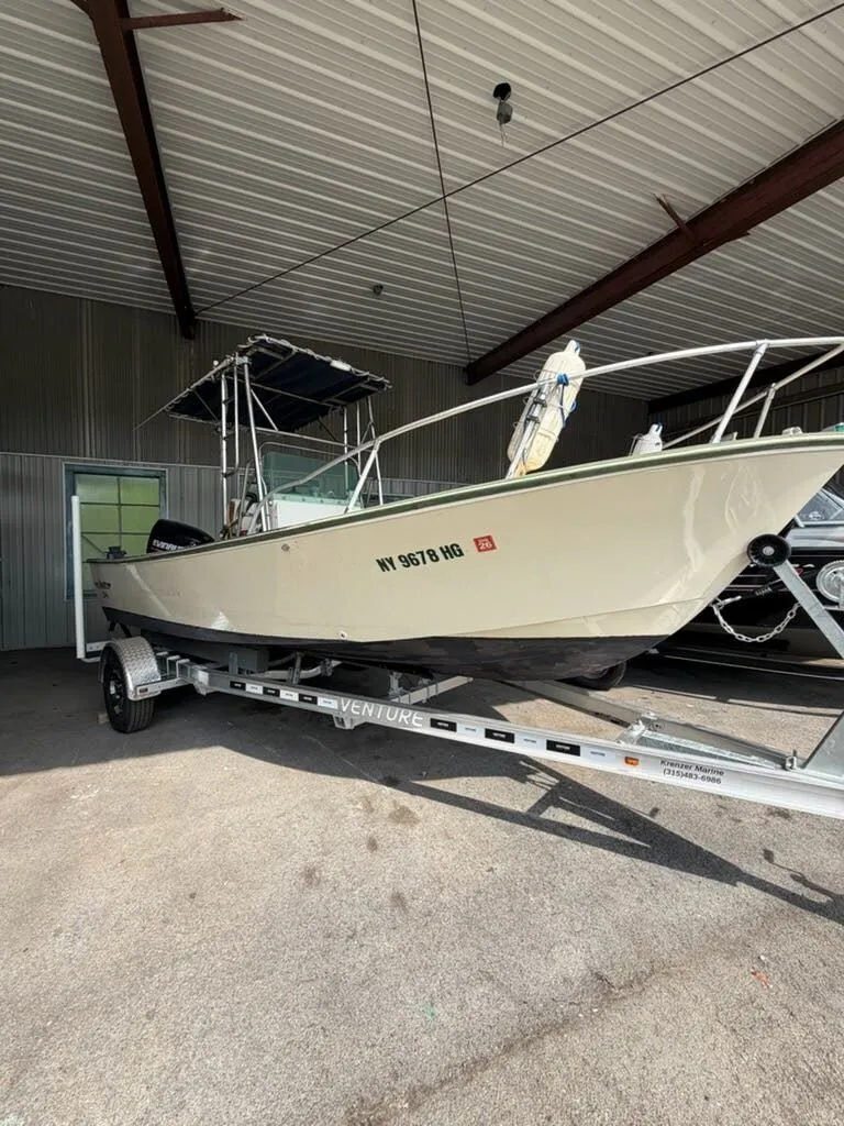 Slide: The Image of A 1974 Aquasport WT20 boat on a trailer inside a warehouse. - 11