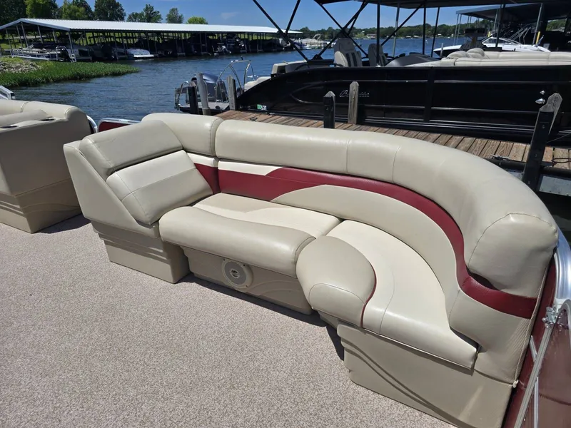 Slide: The Image of The image shows a beige and red seating area on a boat docked at a marina. - 4