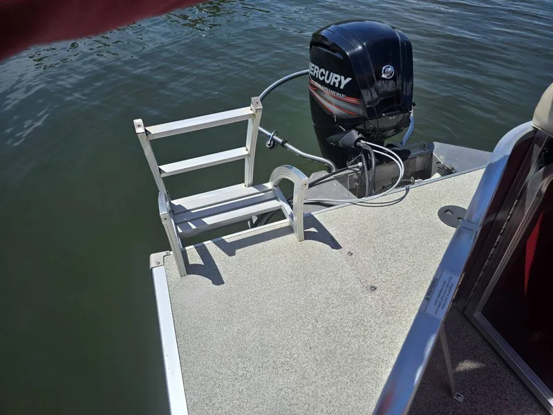 Slide: The Image of The image shows the stern of a boat with a Mercury outboard motor and a ladder. - 10