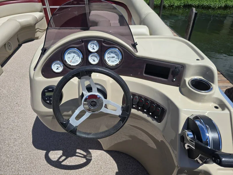 Slide: The Image of The image shows the helm of a 2016 Misty Harbor 245CR with multiple gauges. - 9