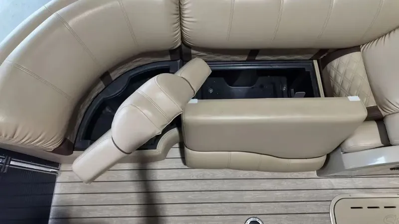 Slide: The Image of The image shows a beige seating area with storage underneath on a boat. - 30