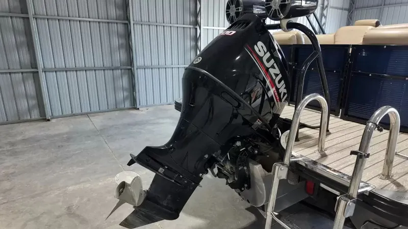 Slide: The Image of A Suzuki outboard motor is mounted on a 2019 Silver Wave 230 Island CLS boat. - 10
