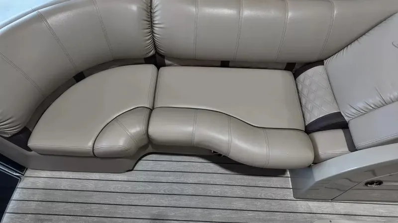 Slide: The Image of The image shows a beige leather seating area on a boat with gray wooden flooring. - 29