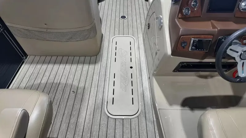 Slide: The Image of The image shows the cockpit of a 2019 Silver Wave 230 Island CLS with beige seats. - 34