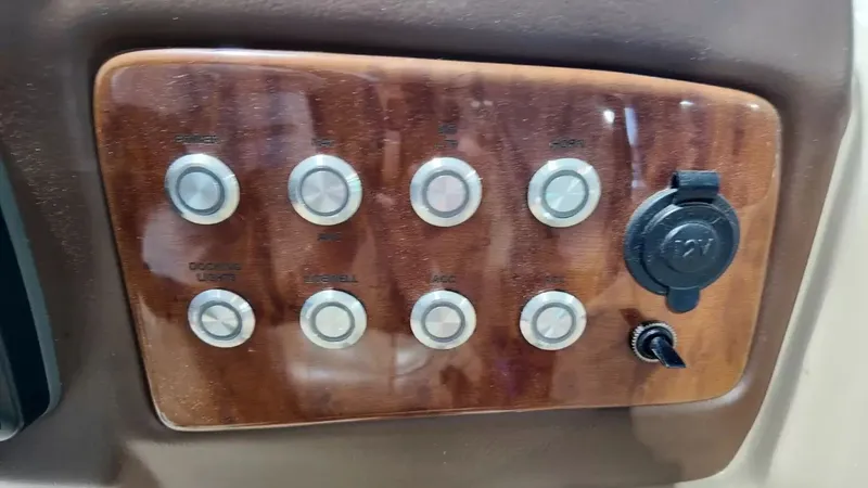 Slide: The Image of Close-up of a boat control panel with multiple buttons and a charging port. - 43