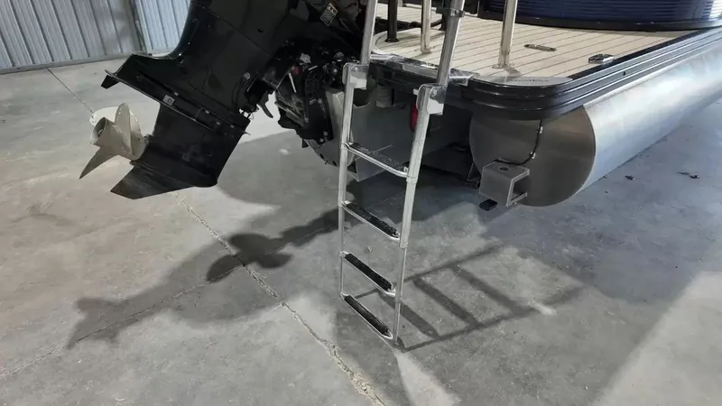Slide: The Image of A silver pontoon boat ladder is attached at the rear of the boat, next to an outboard motor. - 9