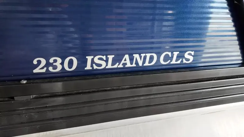 Slide: The Image of Close-up of the "230 Island CLS" lettering on a blue boat hull. - 5