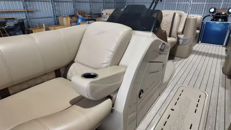 Slide: The Image of The image shows the interior of a 2019 Silver Wave 230 Island CLS with beige leather seating. - 28