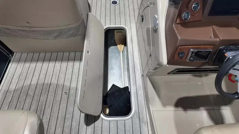 Slide: The Image of The image shows the interior of a 2019 Silver Wave 230 Island CLS with an open storage compartment. - 35