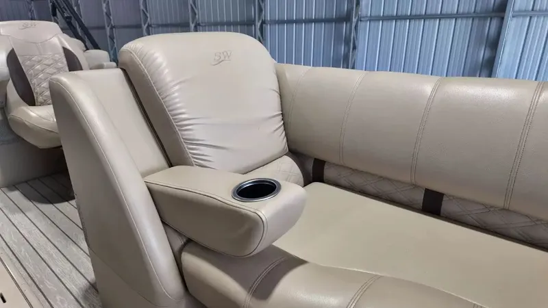 Slide: The Image of The image shows beige leather seating with an armrest and cup holder in a boat. - 32