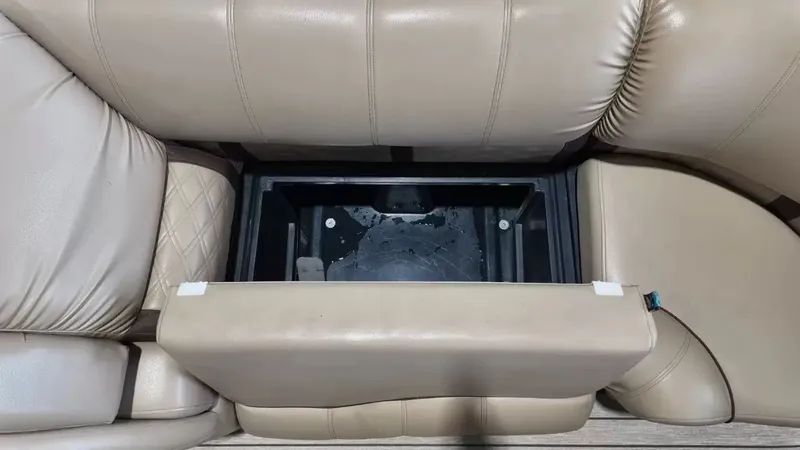 Slide: The Image of A seating area with beige leather upholstery and an open storage compartment beneath. - 24