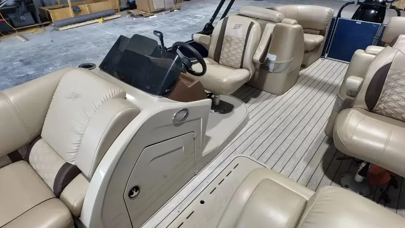Slide: The Image of The image shows the interior of a 2019 Silver Wave 230 Island CLS with beige leather seating. - 38