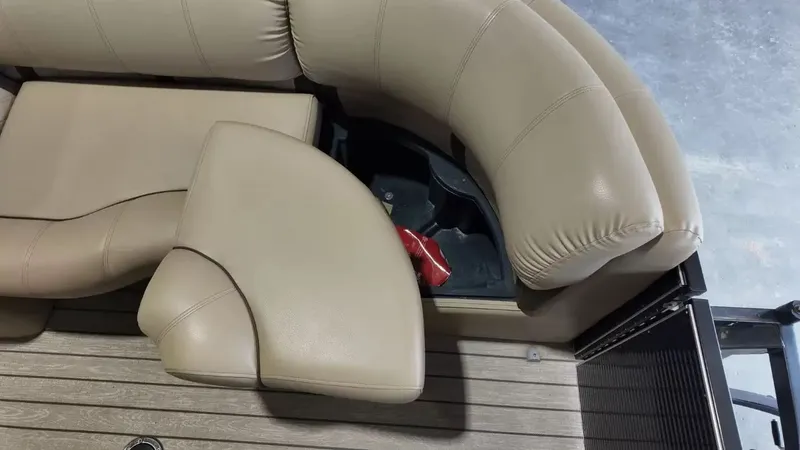 Slide: The Image of The image shows beige upholstery of a boat seat with a small storage compartment underneath. - 26