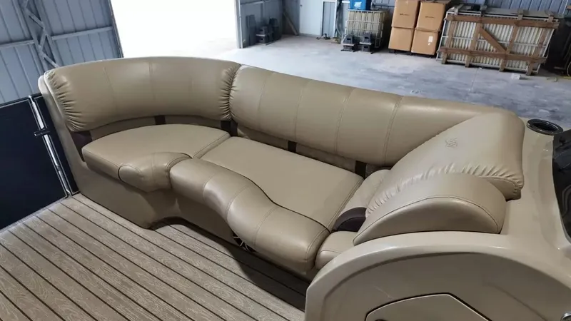 Slide: The Image of The image shows a beige leather seating area on a boat, surrounded by wooden deck flooring. - 27