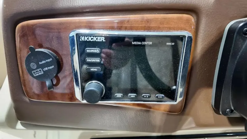 Slide: The Image of The image shows a Kicker media center on a wood-paneled boat dashboard. - 40