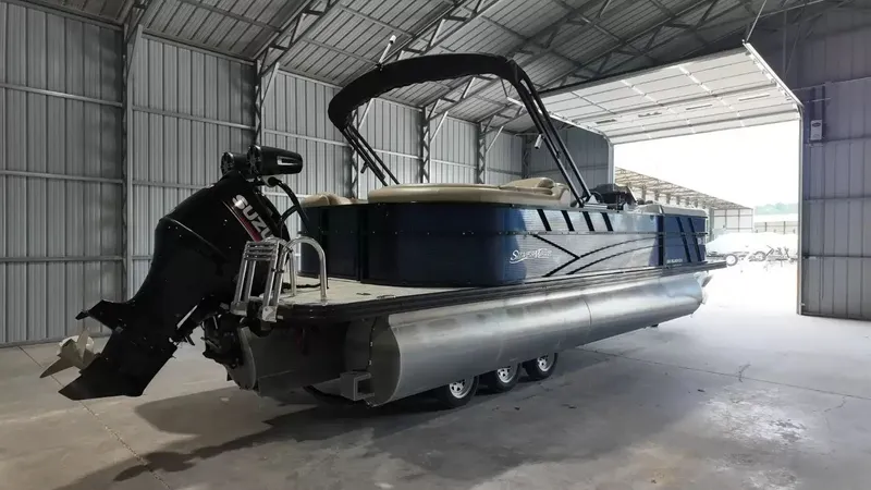Slide: The Image of A 2019 Silver Wave 230 Island CLS pontoon boat in a warehouse, featuring an outboard motor. - 6