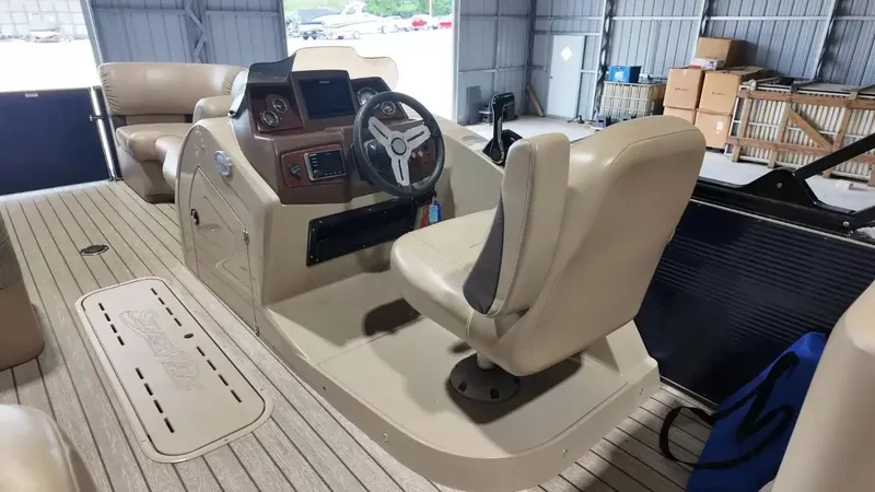 Slide: The Image of The image shows the cockpit of a 2019 Silver Wave 230 Island CLS with beige seating and steering wheel. - 39