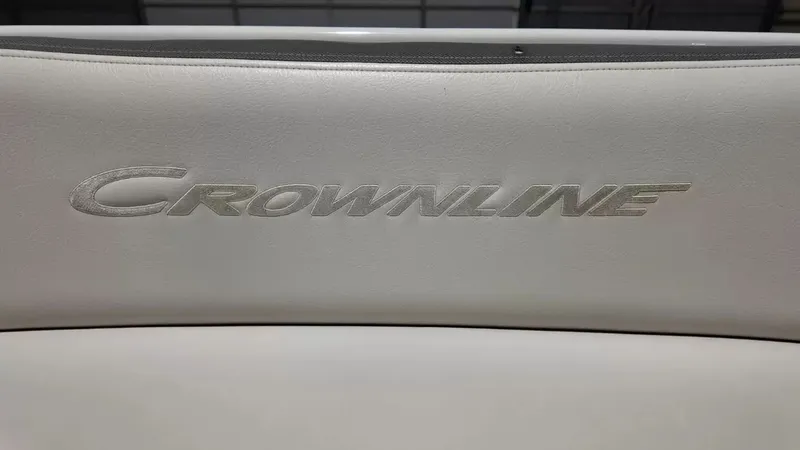 Slide: The Image of Close-up of the Crownline logo on a white seat cushion. - 21