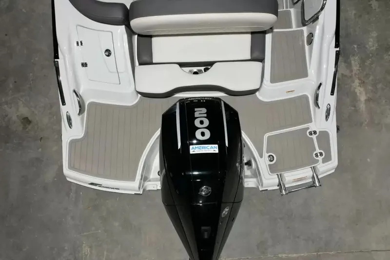 Slide: The Image of The image shows the stern of a 2021 Crownline Eclipse E215 XS boat with an outboard motor. - 45