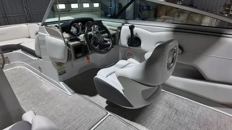 Slide: The Image of The image shows the cockpit of a 2021 Crownline Eclipse E215 XS with gray upholstery. - 30
