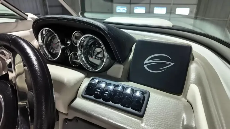 Slide: The Image of The dashboard of a 2021 Crownline Eclipse E215 XS with gauges and switches. - 34