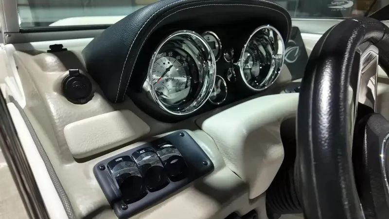 Slide: The Image of Close-up of a 2021 Crownline Eclipse E215 XS boat dashboard with sleek instruments. - 32
