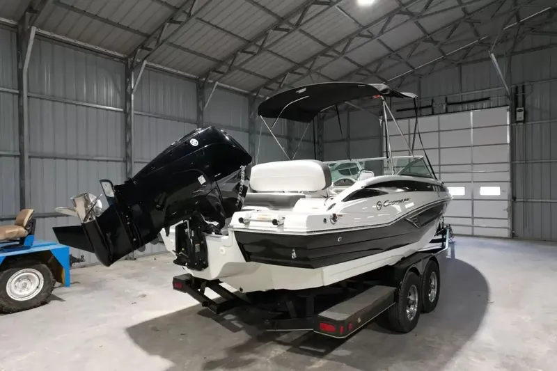 Slide: The Image of A 2021 Crownline Eclipse E215 XS boat is on a trailer inside a warehouse. - 3