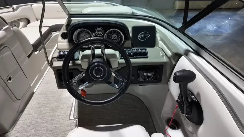 Slide: The Image of The image shows the cockpit of a 2021 Crownline Eclipse E215 XS boat with a modern helm. - 35
