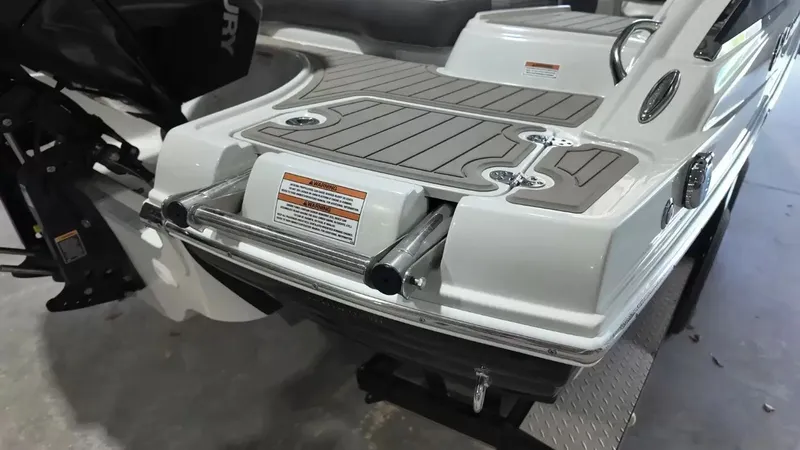 Slide: The Image of The image shows the stern of a 2021 Crownline Eclipse E215 XS boat with a Mercury engine. - 4