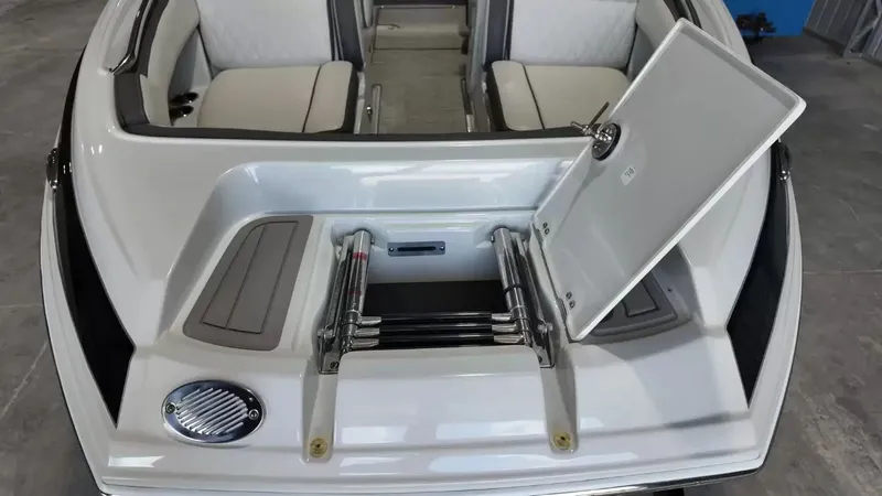 Slide: The Image of The image shows the stern of a 2021 Crownline Eclipse E215 XS boat with an open storage hatch. - 15
