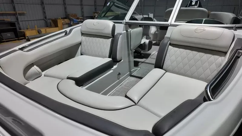 Slide: The Image of The image shows the interior of a 2021 Crownline Eclipse E215 XS boat with sleek, upholstered seating. - 25
