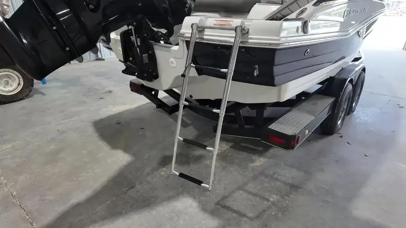 Slide: The Image of A 2021 Crownline Eclipse E215 XS on a trailer in a garage. - 5