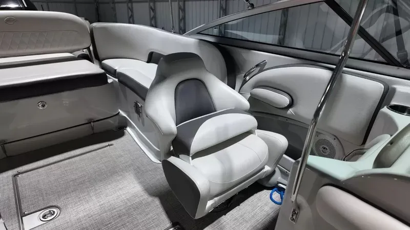 Slide: The Image of The image shows the interior of a 2021 Crownline Eclipse E215 XS boat with gray upholstery. - 36