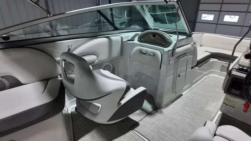 Slide: The Image of Interior of a 2021 Crownline Eclipse E215 XS boat with gray seating and carpeted flooring. - 37