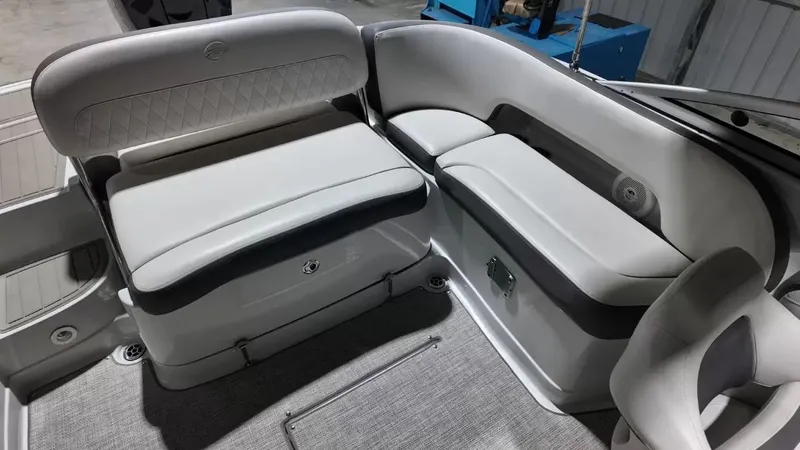 Slide: The Image of The image shows the interior of a 2021 Crownline Eclipse E215 XS boat with gray upholstery. - 40