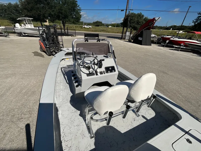 Slide: The Image of Majek 20 Xtreme 2025 with two white seats and a steering console on a parking lot. - 8