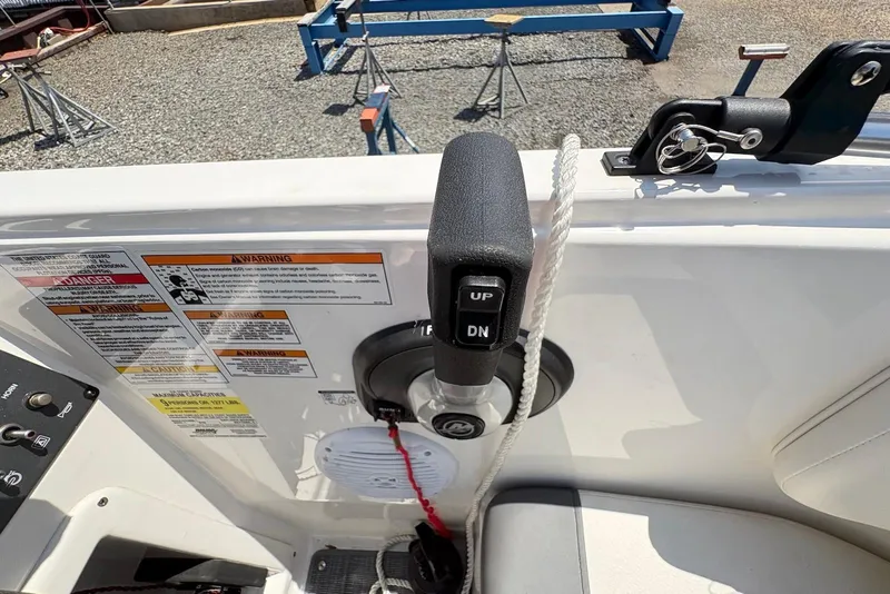 Slide: The Image of 2023 Bayliner Element E18 boat control panel with trim switch and safety warnings. - 3