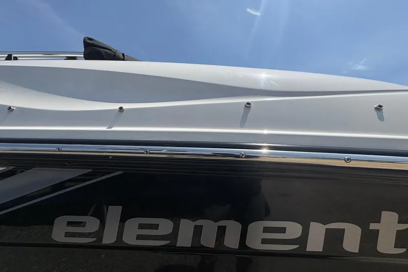 Slide: The Image of 2023 Bayliner Element E18 boat side view with logo under clear blue sky. - 8