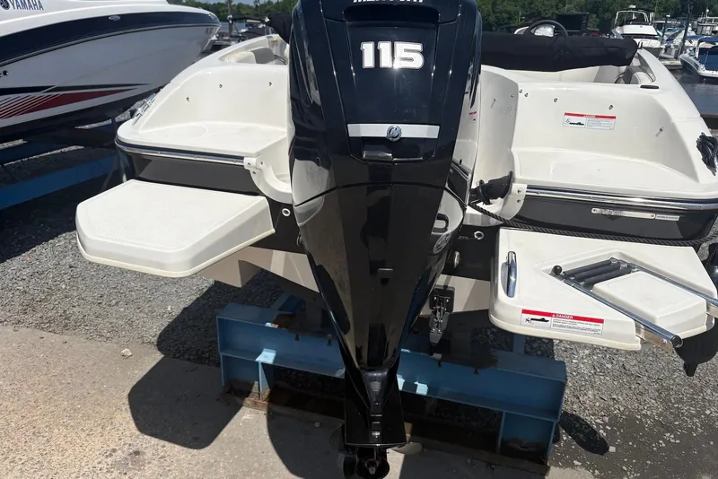 Slide: The Image of 2023 Bayliner Element E18 boat with 115 HP engine, docked outdoors. - 5