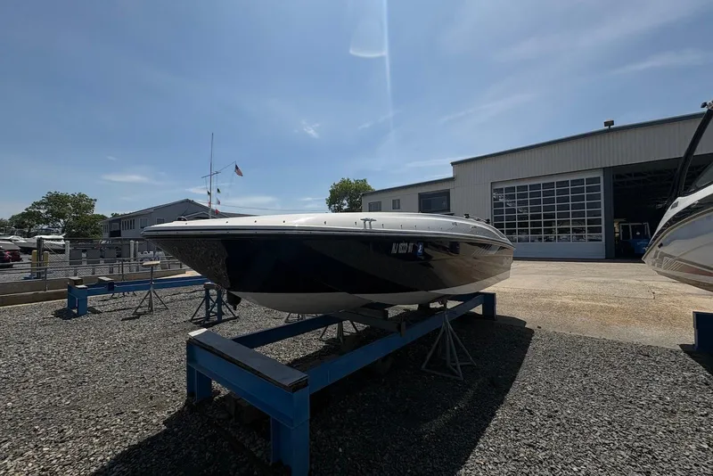 Slide: The Image of 2023 Bayliner Element E18 boat on display at a marina under clear skies. - 1