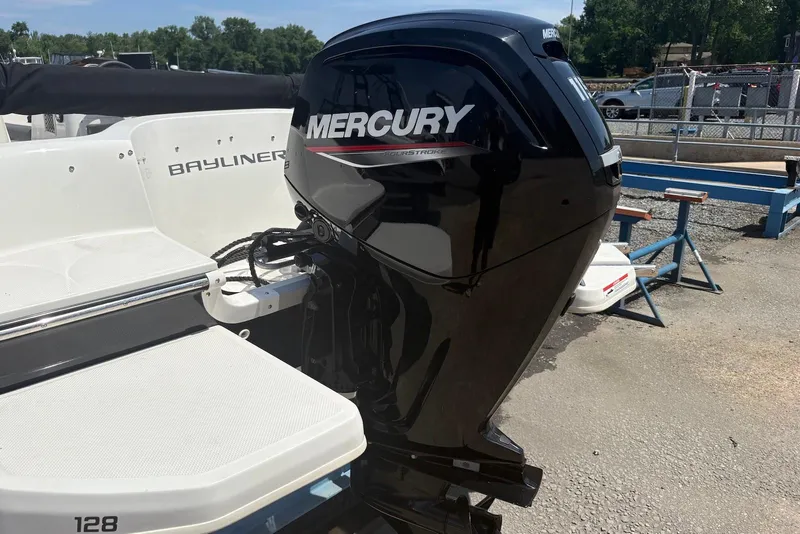 Slide: The Image of 2023 Bayliner Element E18 boat with Mercury outboard motor, docked outdoors. - 6