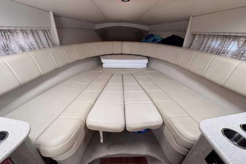 Slide: The Image of 2007 Formula 330 Sun Sport cabin interior with beige seating and curtains. - 18