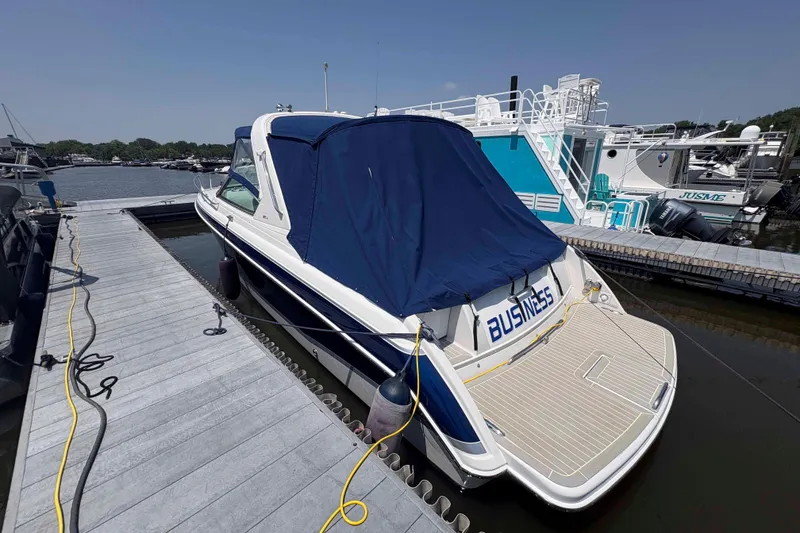 Slide: The Image of 2007 Formula 330 Sun Sport boat docked with blue cover, labeled "BUSINESS." - 9