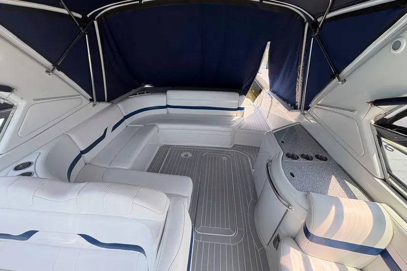 Slide: The Image of 2007 Formula 330 Sun Sport boat interior with white seating and blue accents. - 2